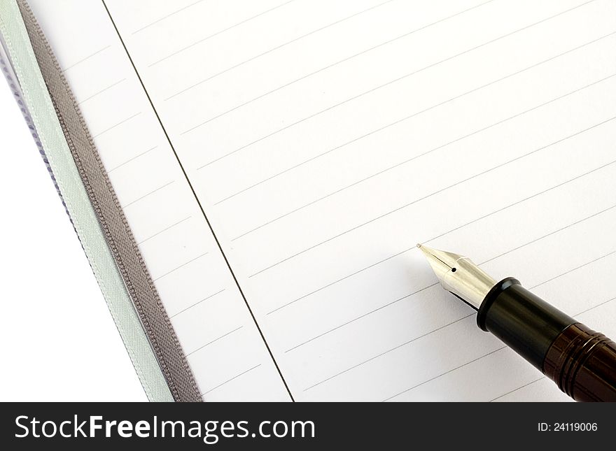 Fountain pen on lined empty business notebook ready for text. Fountain pen on lined empty business notebook ready for text