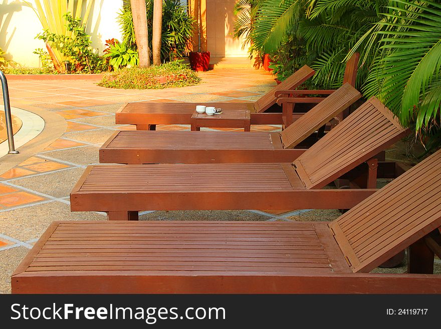 Wooden pool trestle beds by the poolside