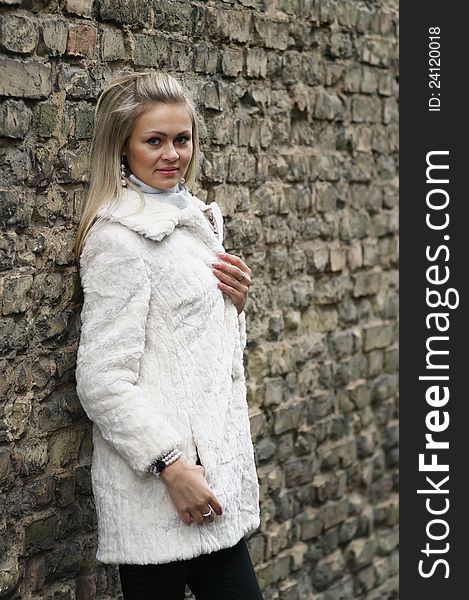 Upset Young Woman In White Fur Coat