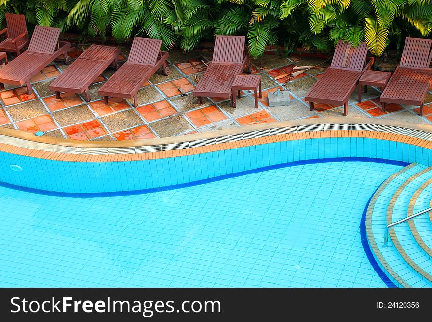 Wooden pool trestle beds by the poolside