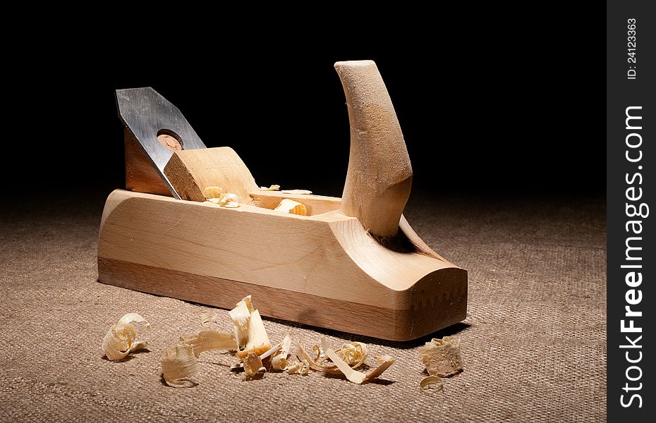 Carpenter plane with shavings on jute