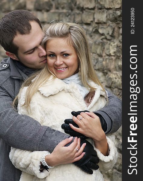 Young Woman Smiles In The Arms Of Her Boyfriend Vertical