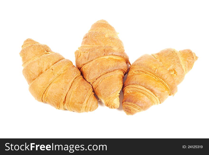 Four french croissants on white background