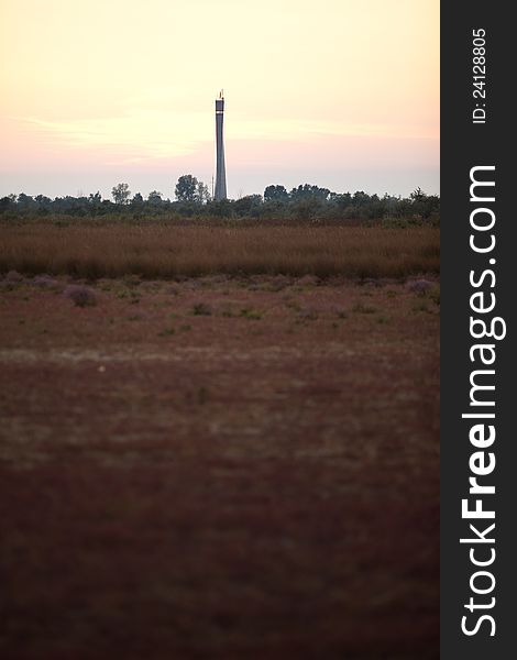 Lighthouse in deserted low vegetation landscape, at sunset. Lighthouse in deserted low vegetation landscape, at sunset