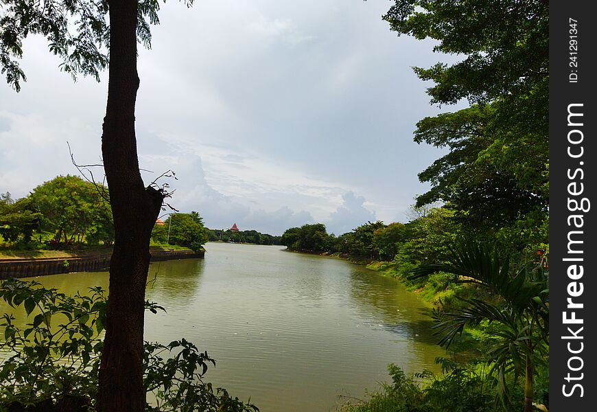 Beautiful lake of `Situ Babakan` with greeny around, Jakarta, Indonesia - 2022. Excellent view wave water among green trees