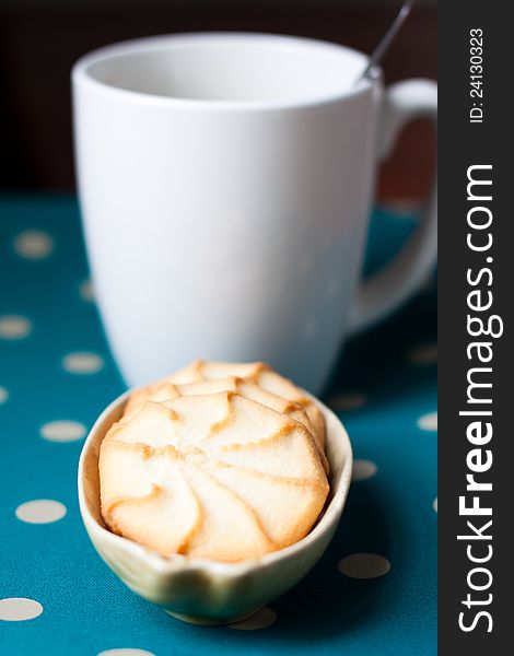 Plate of coffee and a cup of coffee on green polka dot table. Plate of coffee and a cup of coffee on green polka dot table