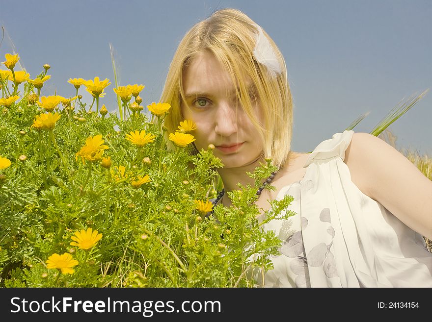 Beautiful young girl in a green spring meadow with daisies. Beautiful young girl in a green spring meadow with daisies.