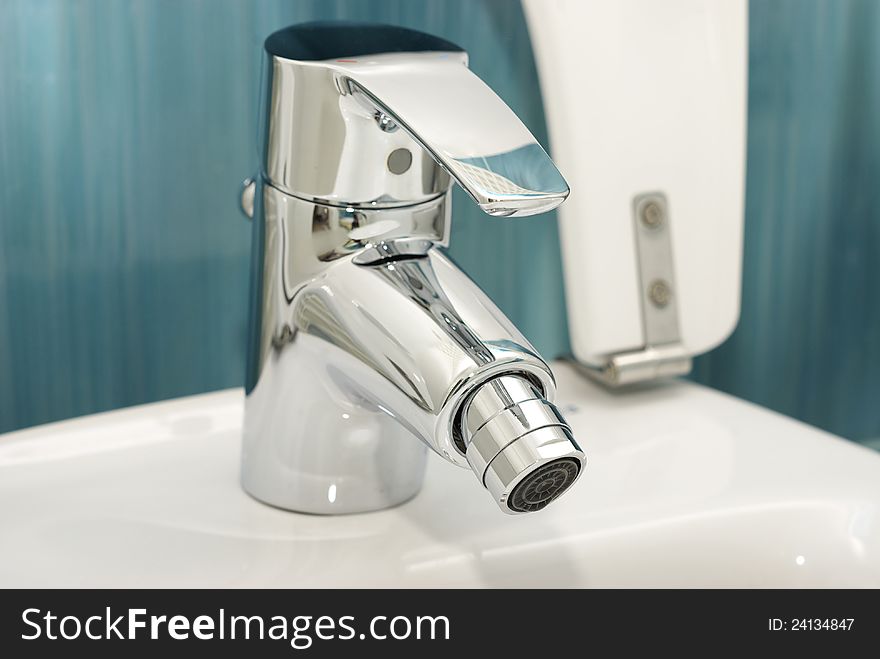 White toilet bidet object in a clean room with a metal faucet. White toilet bidet object in a clean room with a metal faucet