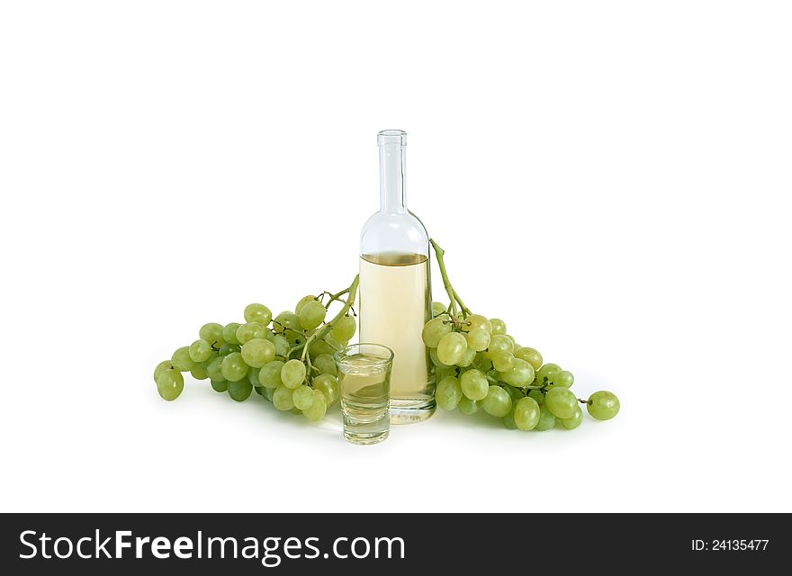 Open bottle of Italian vodka �grappa� near wineglass and bunch of grapes on white background. Clipping path is included. Open bottle of Italian vodka �grappa� near wineglass and bunch of grapes on white background. Clipping path is included