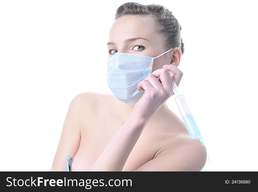 Beautiful passionate nurse with a syringe in a mask