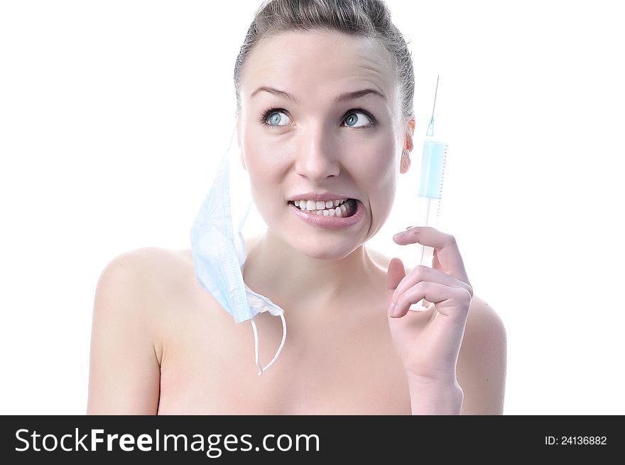Beautiful funny nurse with a syringe in a mask