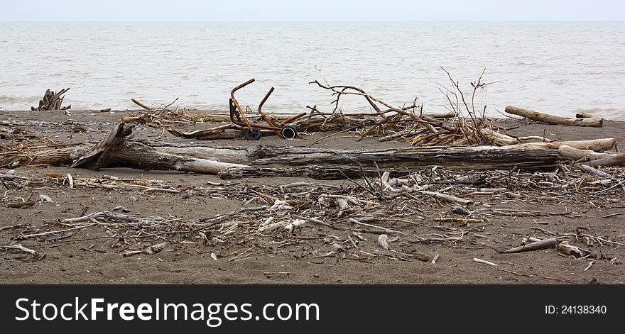 Isolated beach with driftwood in and collection of junk. Isolated beach with driftwood in and collection of junk