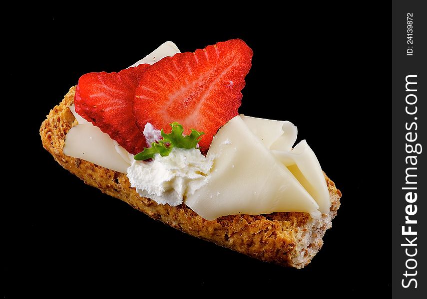 CreaspBread sandwich with cheese and strawberry isolated on black background