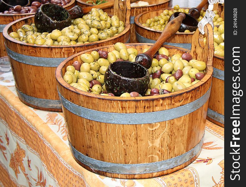 Wooden Barrels Displaying Fresh Olives for Sale.