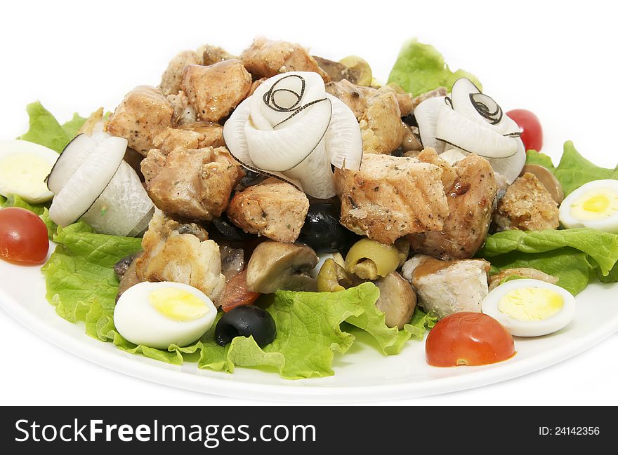 Salad of fish and eggs on a white plate in a restaurant