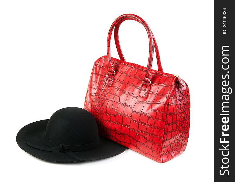 Red Fashion ladies handbag and a black felt hat in the studio on a white background