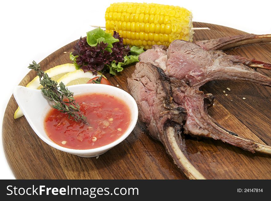 Grilled ribs with sauce and corn on a plate