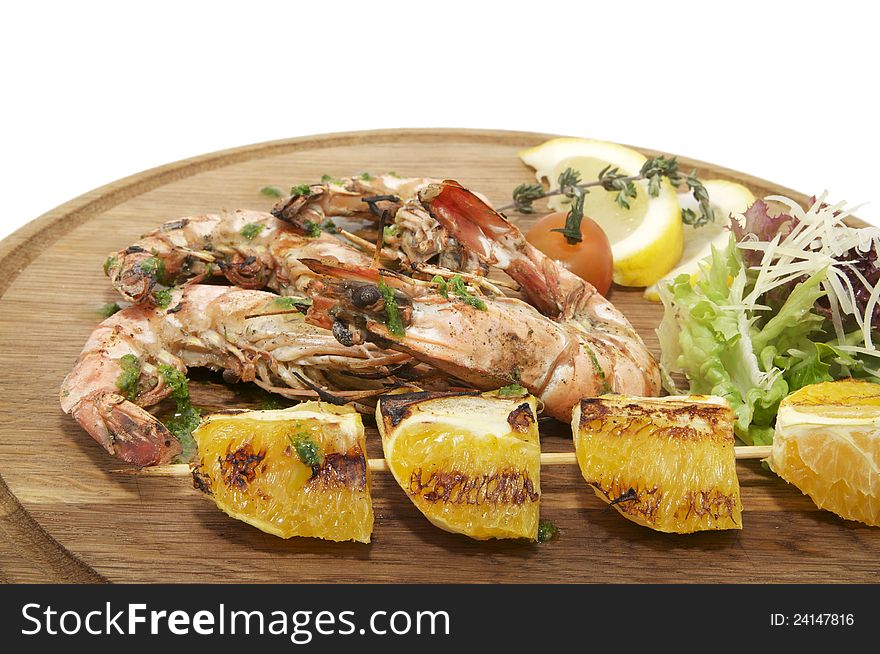 Grilled Shrimp with Orange on a wooden plate