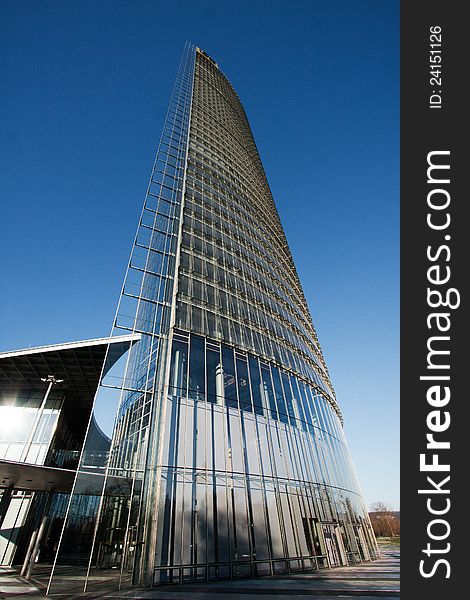 New designed glassy business building on the blue sky. New designed glassy business building on the blue sky