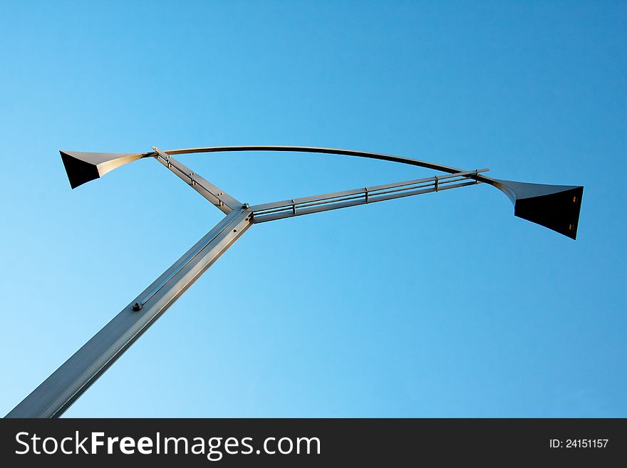 Modern designed city lamp over the blue sky. Modern designed city lamp over the blue sky