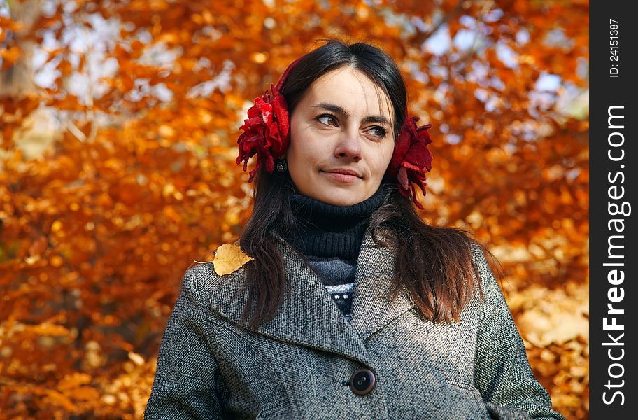 Close up portrait of a young woman with autumn trees on the background. Close up portrait of a young woman with autumn trees on the background.