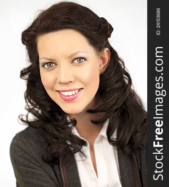 Beautiful young woman with long, brown, curla hair, close-up on white background