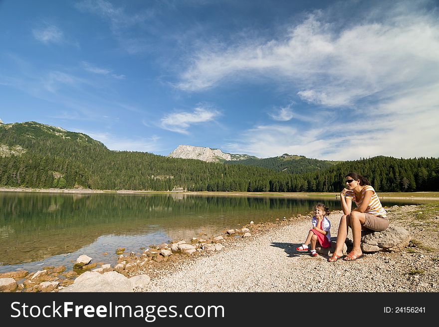 Woman and girl near lake