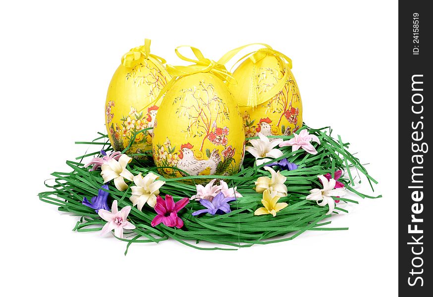 Three decorated easter eggs in the grass with hyacinth