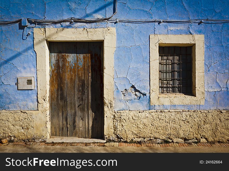 Typical Mediterranean facade blue width old door and window