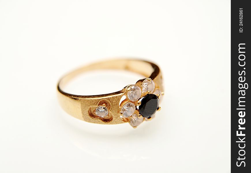 Yellow gold ring with black gemstone, towards white