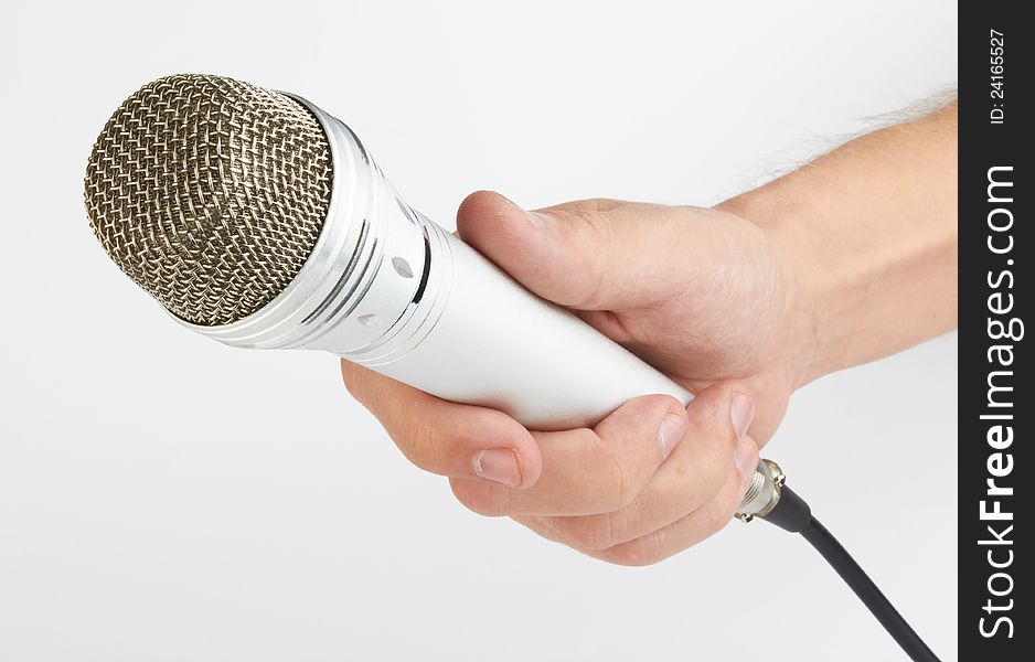 Hand with a microphone on white