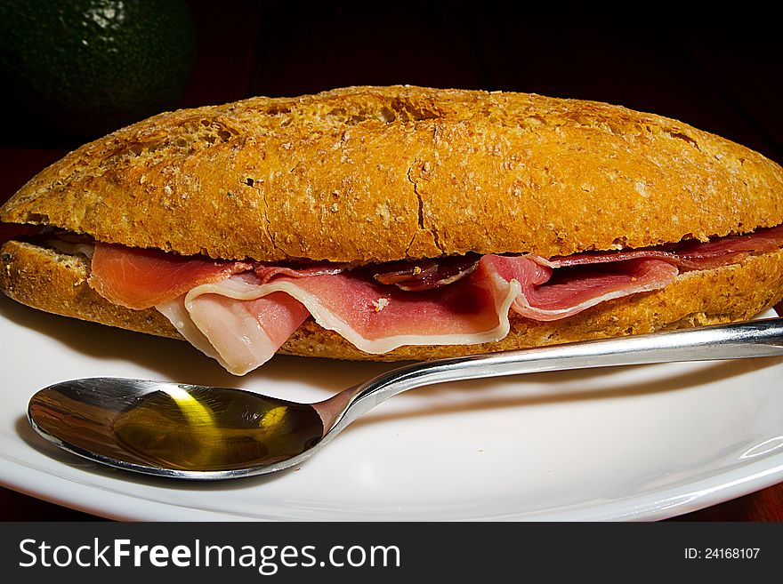 Jamon - Spanish Cured Ham on Brown Bread with spoon of olive oil. Jamon - Spanish Cured Ham on Brown Bread with spoon of olive oil