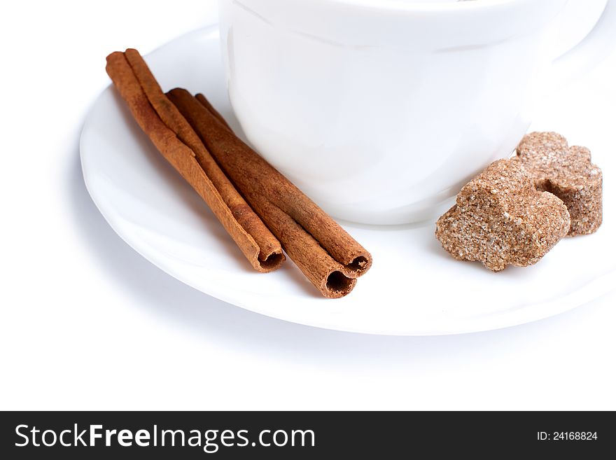 Two sticks of cinnamon with sugar on plate