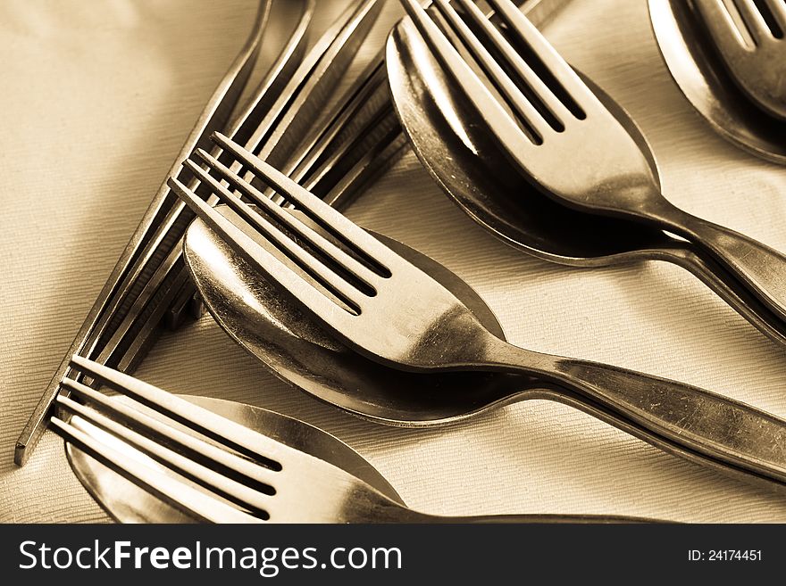 Close-up of many pair of spoon and fork on table. Close-up of many pair of spoon and fork on table