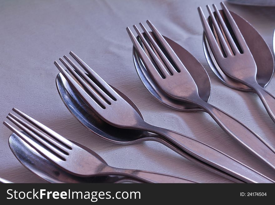 Close-up of many pair of spoon and fork on table