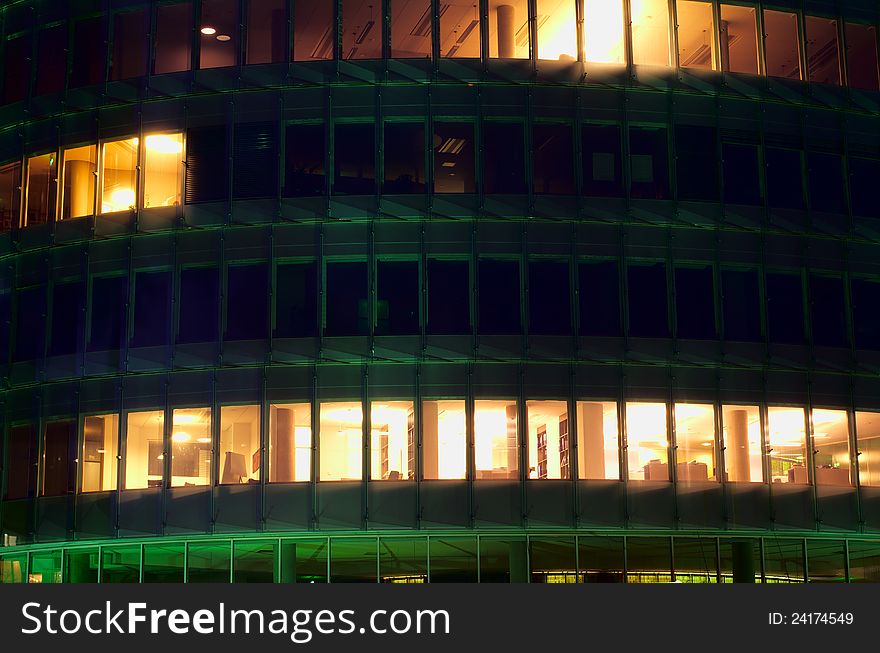 A night-time officebuilding with lights in the windows, closeup. A night-time officebuilding with lights in the windows, closeup