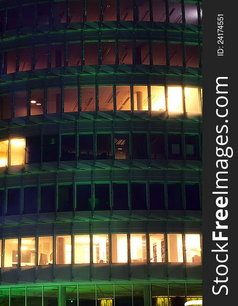 A night-time officebuilding with lights in the windows, closeup. A night-time officebuilding with lights in the windows, closeup