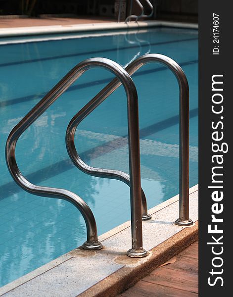 Close-up of swimming pool with stair at hotel , vacation background. Close-up of swimming pool with stair at hotel , vacation background