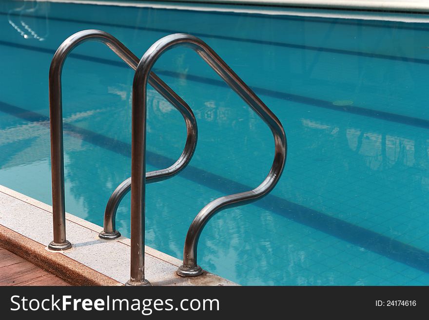 Close-up of swimming pool with stair at hotel , vacation background. Close-up of swimming pool with stair at hotel , vacation background