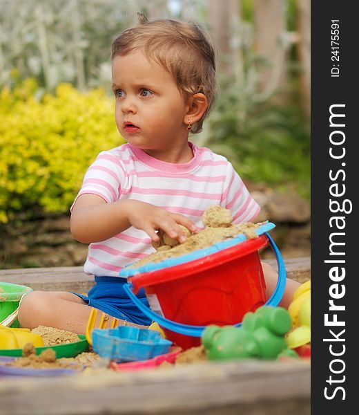 Little girl playing with sandbox. Little girl playing with sandbox