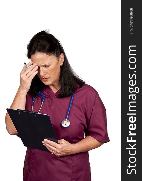 Mature female healthcare worker too tired to think. Wearing burgundy scrubs with blue stethoscope and isolated on a white background. Mature female healthcare worker too tired to think. Wearing burgundy scrubs with blue stethoscope and isolated on a white background.