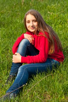 Beautiful Teenage Girl Sitting In The Grass Royalty Free Stock Photos