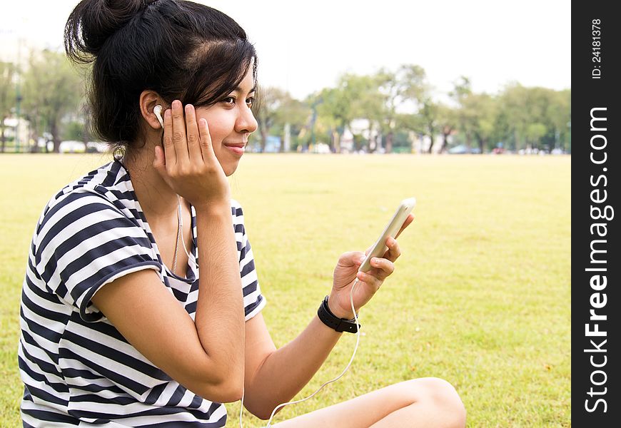 Young girl with headphones outdoors. Listening music. Young girl with headphones outdoors. Listening music