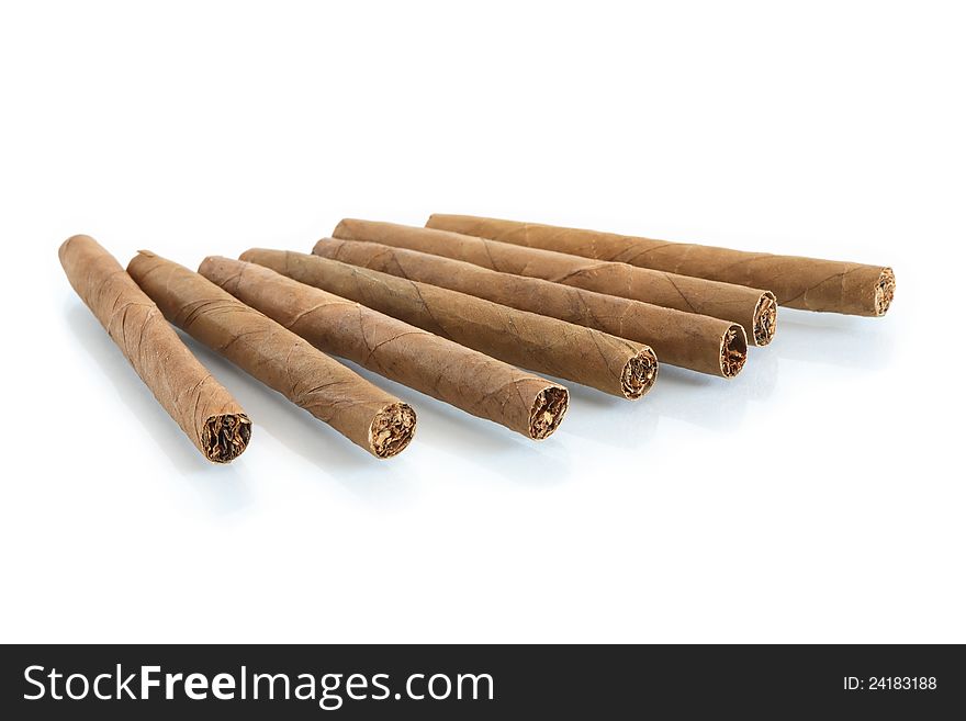 Few cigars in a row on white background with reflection. Few cigars in a row on white background with reflection
