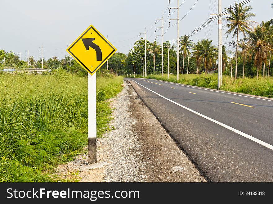 Curved road to the left signpost, asphalt road background. Curved road to the left signpost, asphalt road background