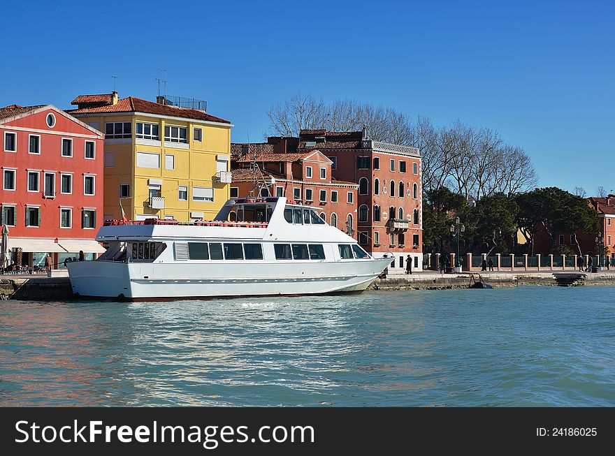 White boat on the pier. Perfect sunny day. Venice, Italy. White boat on the pier. Perfect sunny day. Venice, Italy.