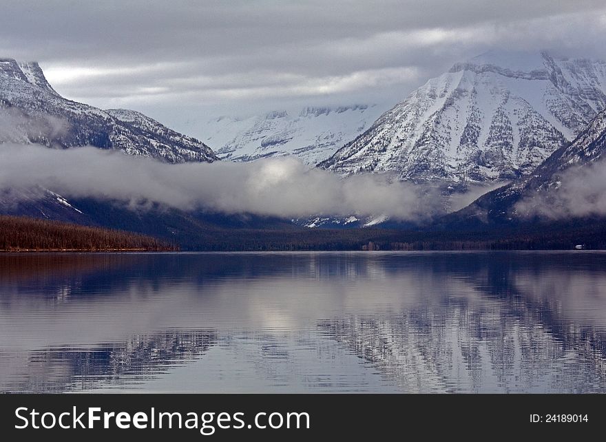 This image of Lake McDonald with the reflection and low clouds was taken in Glacier National Park, MT. This image of Lake McDonald with the reflection and low clouds was taken in Glacier National Park, MT.