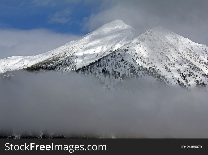 This image of Stanton Mountain with the low clouds was taken in Glacier National Park, MT. This image of Stanton Mountain with the low clouds was taken in Glacier National Park, MT.