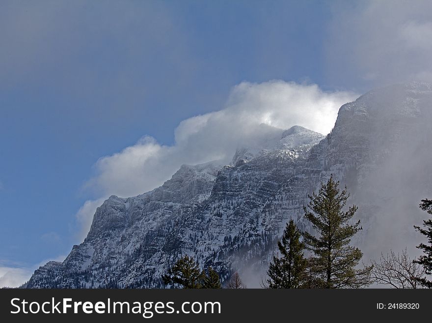 This image of the rugged snowy mountains with the storm clouds moving in was taken in Glacier National Park, MT. This image of the rugged snowy mountains with the storm clouds moving in was taken in Glacier National Park, MT.