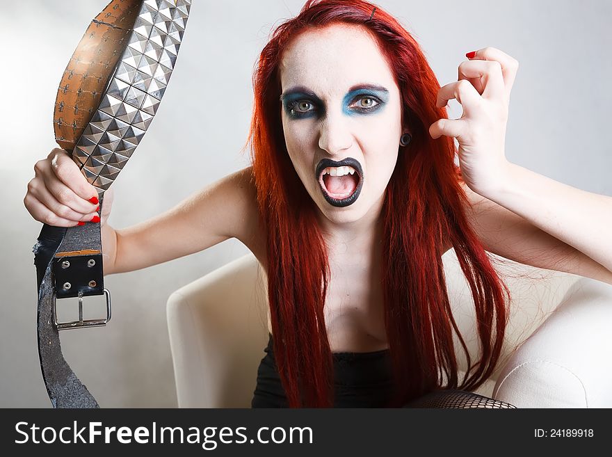 Studio shot of expressive gothic red haired woman with artistic makeup over white background. Studio shot of expressive gothic red haired woman with artistic makeup over white background